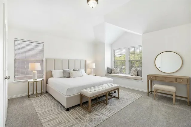 a bedroom with a large bed and a large window