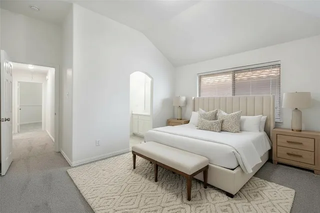 a bedroom with a bed and a night stand