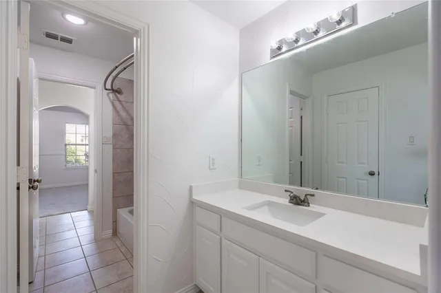 a bathroom with a sink vanity and a mirror