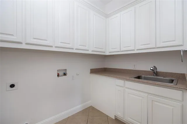 a kitchen with granite countertop white cabinets and a sink