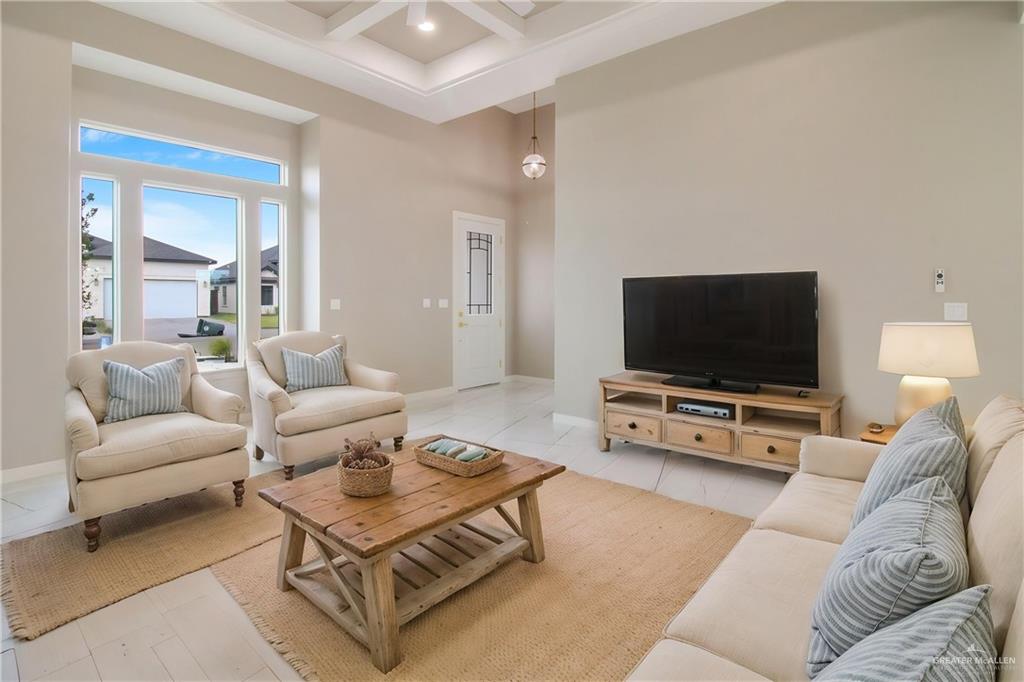 909 Azalea Street Mission, TX 78573 - Photo 12 of 29 Living area with coffered ceiling and baseboards