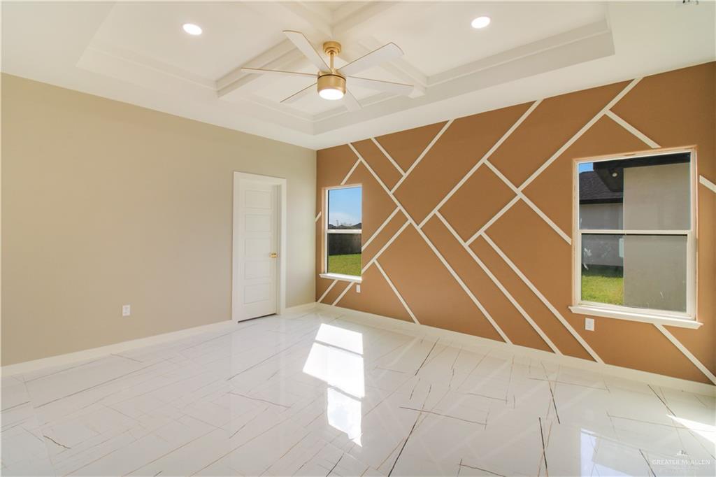 909 Azalea Street Mission, TX 78573 - Photo 15 of 29 Spare room with an accent wall, ceiling fan, recessed lighting, and coffered ceiling