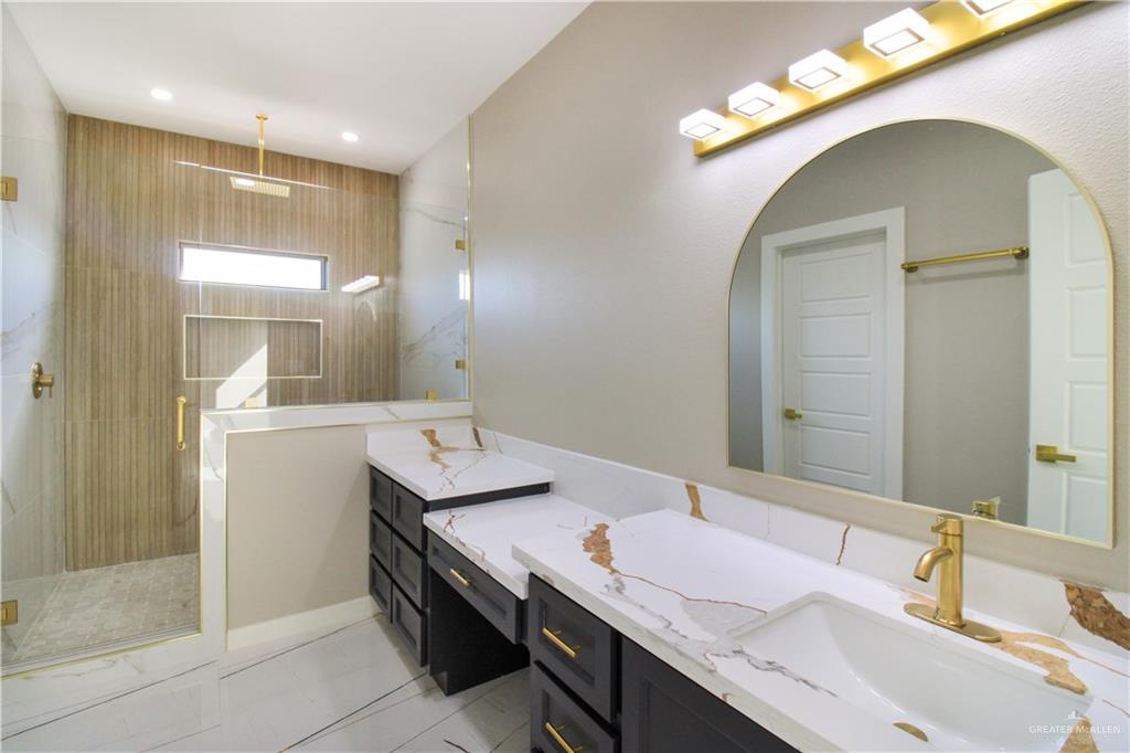 909 Azalea Street Mission, TX 78573 - Photo 17 of 29 Main Bathroom with a beutiful finishe, shower a big vanities. Plenty of storage