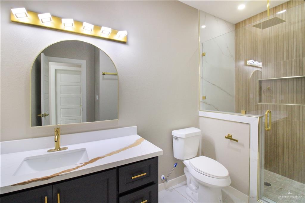 909 Azalea Street Mission, TX 78573 - Photo 22 of 29 Full bath with vanity and a modern design finish shower