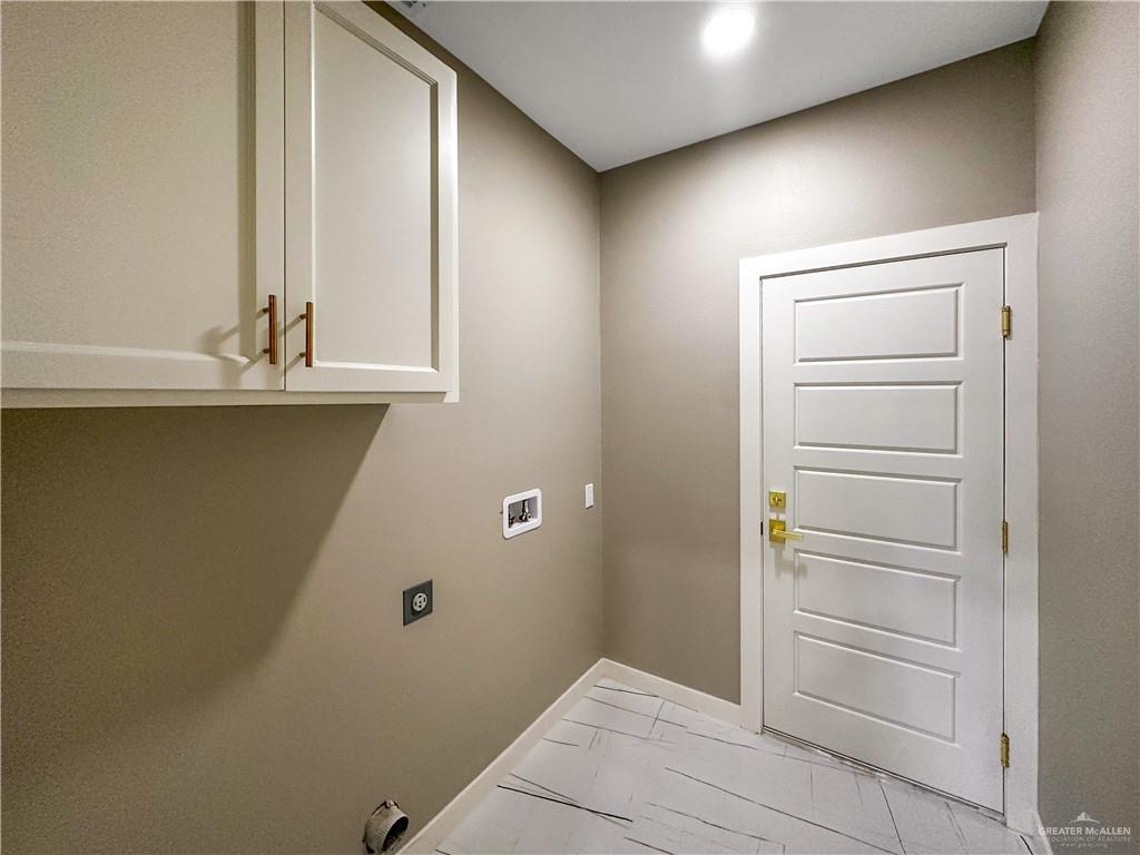 909 Azalea Street Mission, TX 78573 - Photo 24 of 29 Laundry room with cabinet space, hookup for a washing machine, and electric dryer hookup
