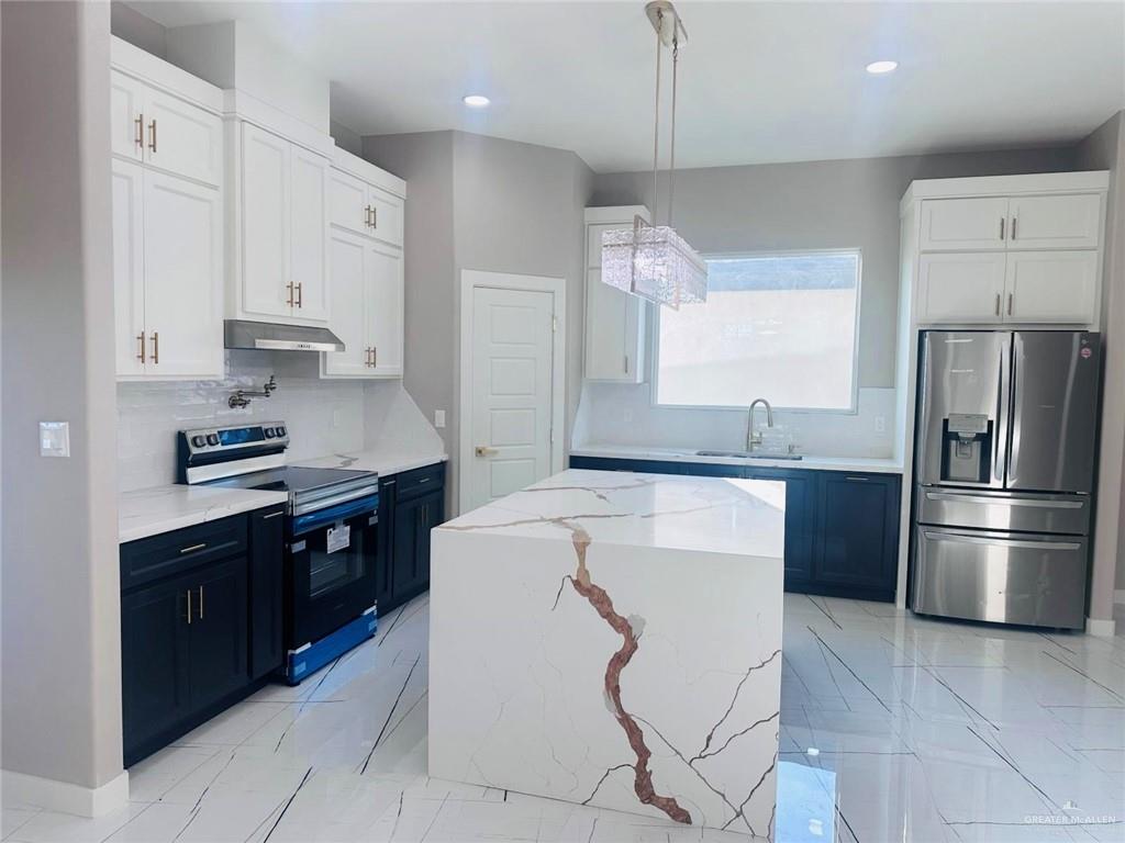 909 Azalea Street Mission, TX 78573 - Photo 4 of 29 Beutiful island, stainless steel fride, stove and vent.