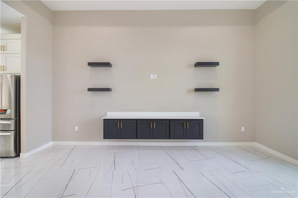 909 Azalea Street Mission, TX 78573 - Photo 8 of 29 Unfurnished living room with baseboards