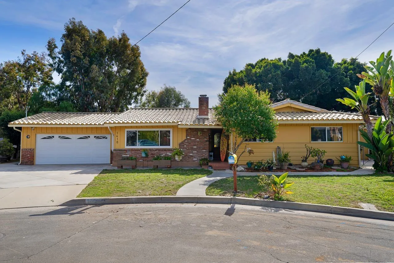 a front view of house with yard and outdoor seating