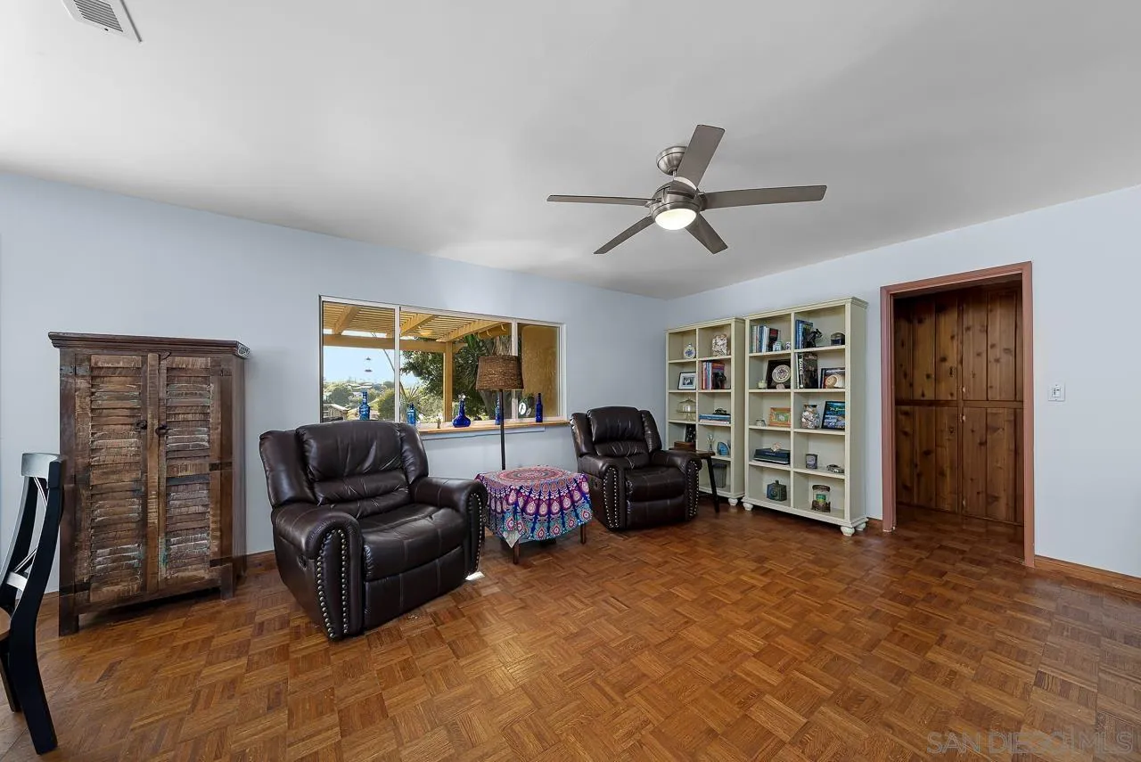 1410 Crestridge Drive Oceanside, CA 92054 - Photo 17 of 71 a living room with furniture and gym equipment