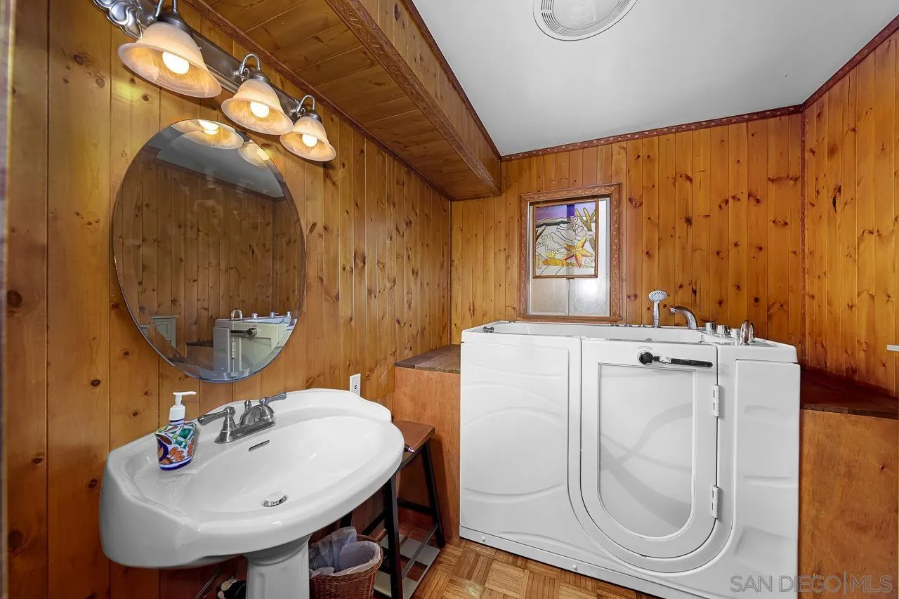 1410 Crestridge Drive Oceanside, CA 92054 - Photo 22 of 71 a bathroom with a sink mirror and vanity