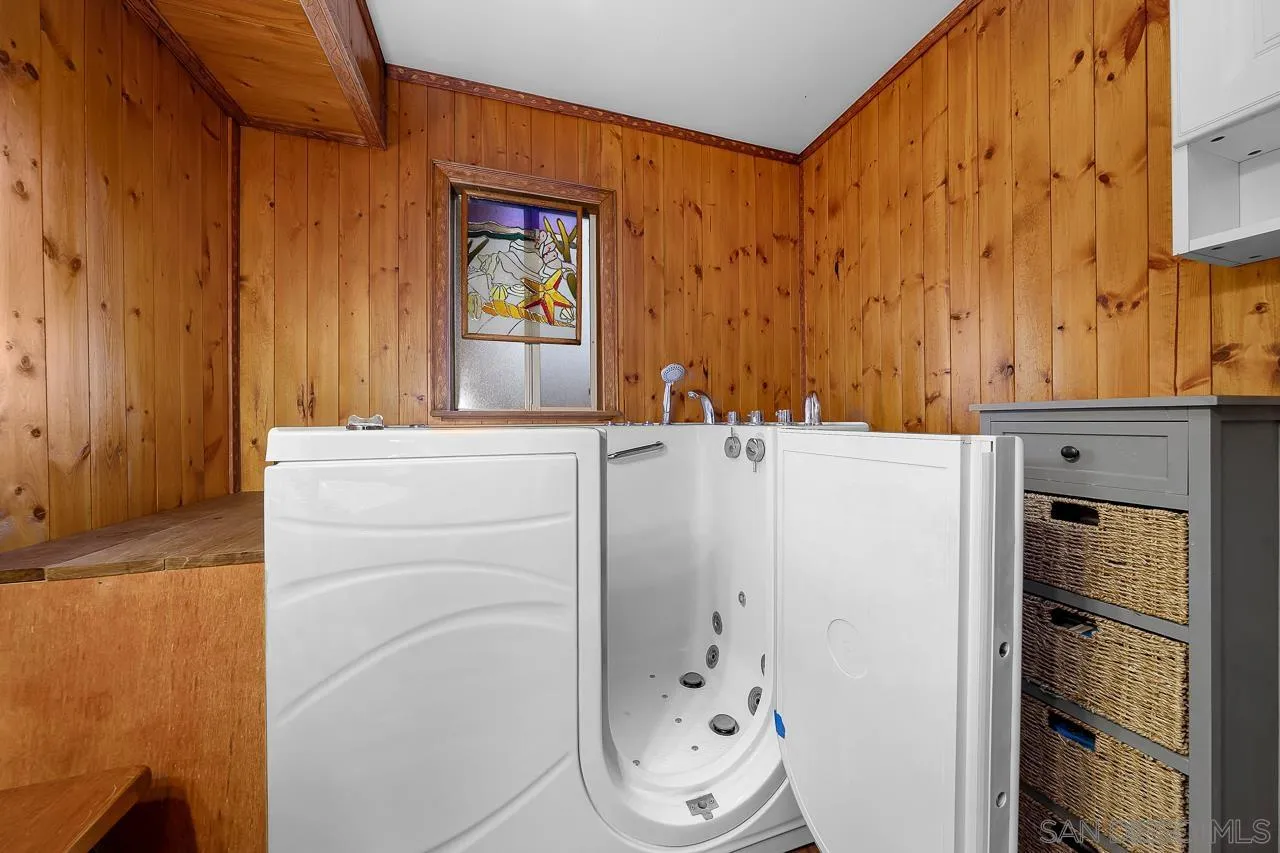 1410 Crestridge Drive Oceanside, CA 92054 - Photo 23 of 71 a bathroom with a sink a toilet and shower curtain