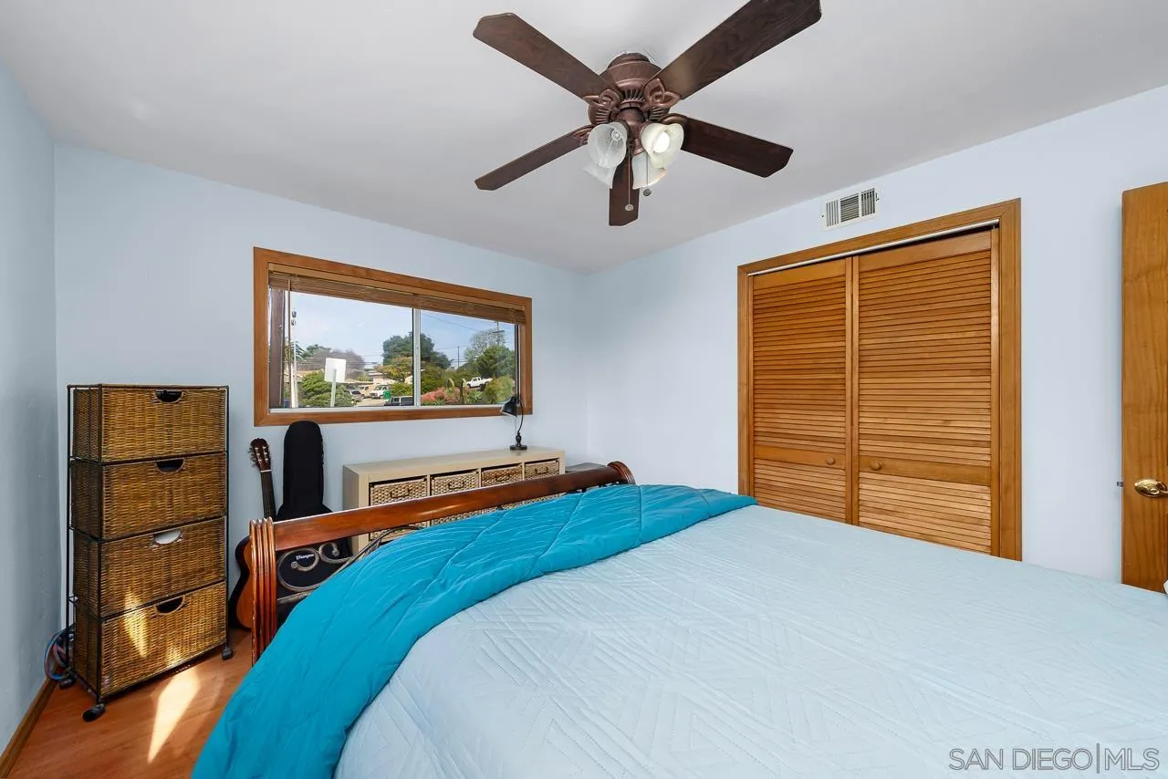 1410 Crestridge Drive Oceanside, CA 92054 - Photo 26 of 71 a bedroom with a bed and a flat screen tv