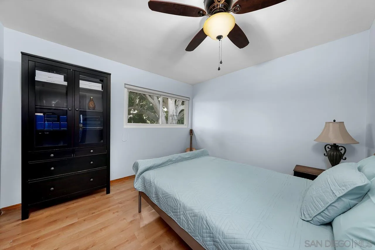 1410 Crestridge Drive Oceanside, CA 92054 - Photo 29 of 71 a bedroom with a bed and wooden floor