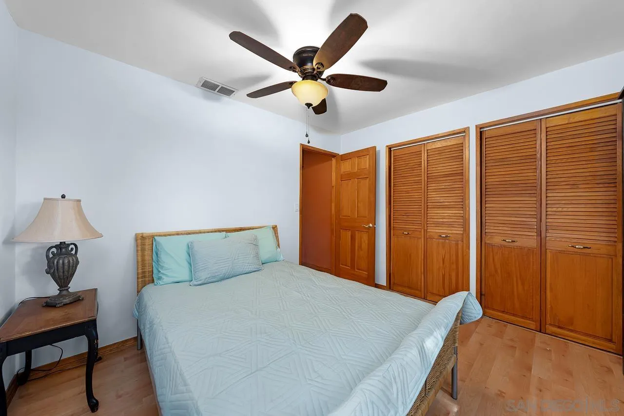 1410 Crestridge Drive Oceanside, CA 92054 - Photo 30 of 71 a bed room with a bed and a ceiling fan