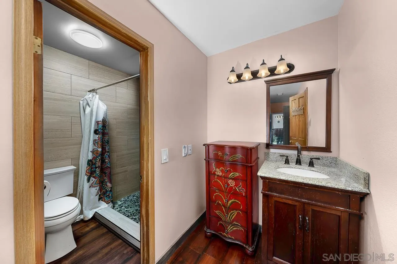 1410 Crestridge Drive Oceanside, CA 92054 - Photo 31 of 71 a bathroom with a sink a toilet and shower