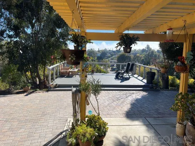 1410 Crestridge Drive Oceanside, CA 92054 - Photo 52 of 71 a view of a patio with table and chairs potted plants