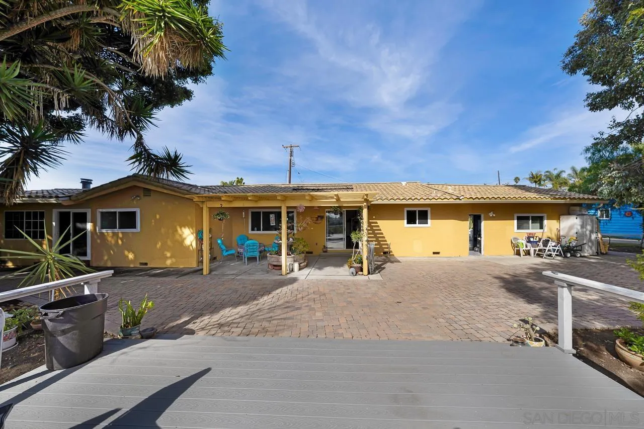 1410 Crestridge Drive Oceanside, CA 92054 - Photo 57 of 71 a front view of a house with yard and parking