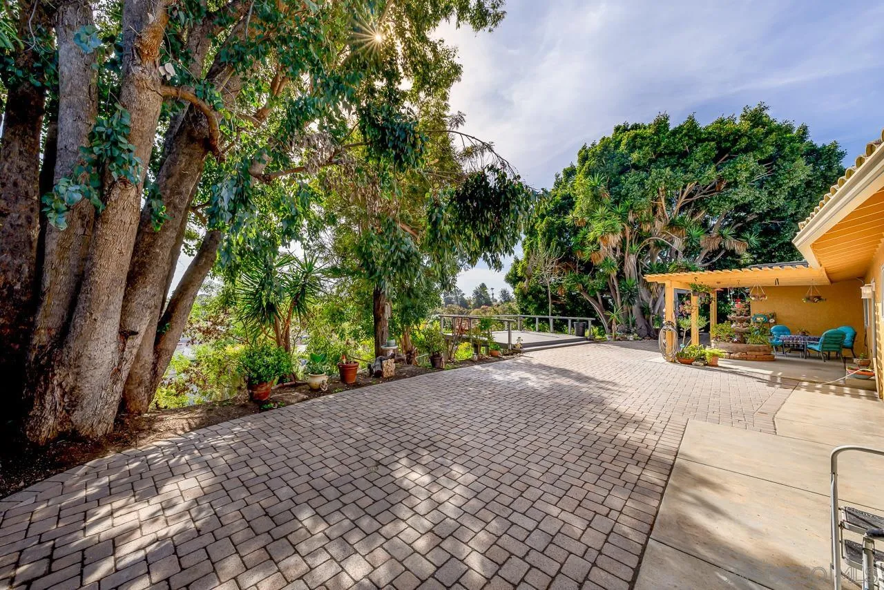 1410 Crestridge Drive Oceanside, CA 92054 - Photo 62 of 71 a pathway of a house with a yard and sitting area