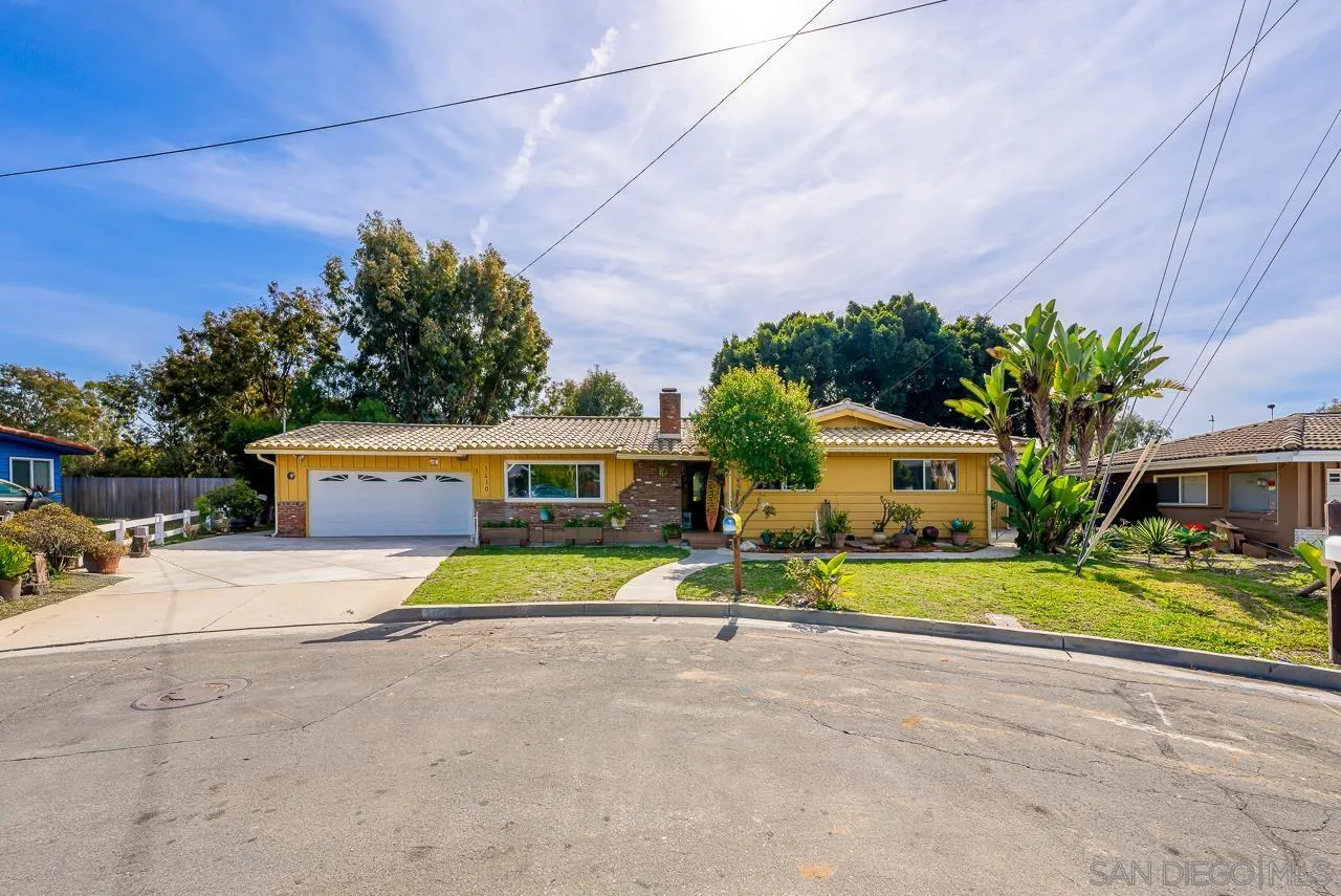 1410 Crestridge Drive Oceanside, CA 92054 - Photo 69 of 71 a front view of a house with a yard and garage