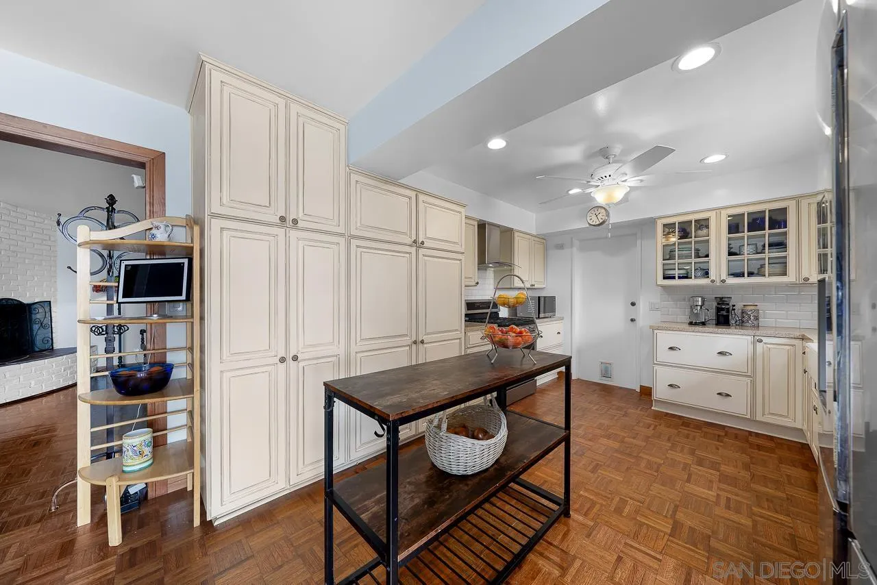 1410 Crestridge Drive Oceanside, CA 92054 - Photo 9 of 71 a kitchen with stainless steel appliances kitchen island granite countertop a refrigerator and microwave