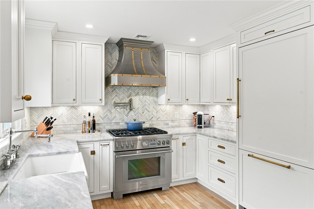 2269 East Main Road Portsmouth, RI 02871 - Photo 15 of 50 CopperSmith hood, marble countertops and backsplash, brass hardware, and so much more.