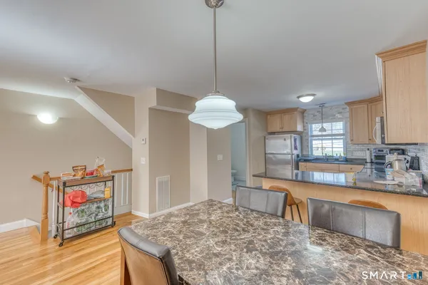 a kitchen with granite countertop sink and wooden floor