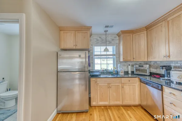a kitchen with a refrigerator sink and cabinets