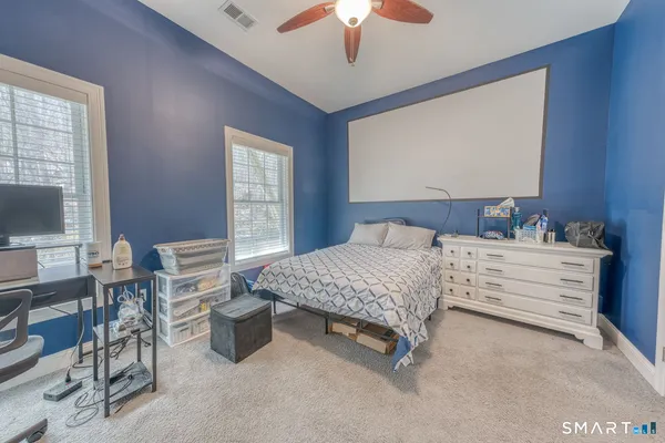 a bedroom with bed and a chandelier