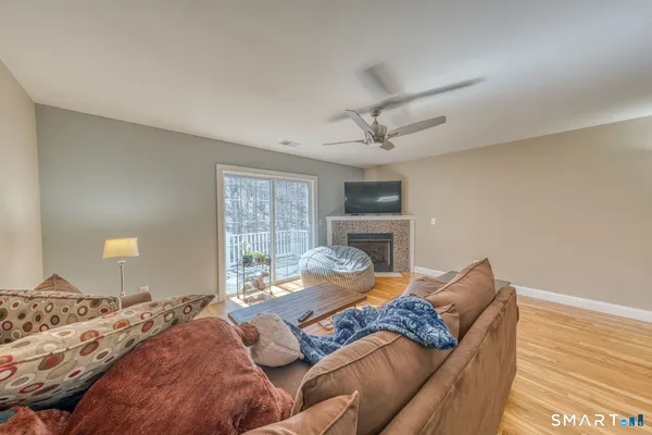 a bedroom with a bed couch and wooden floor