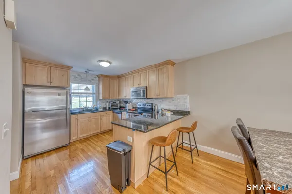 a kitchen with cabinets and wooden floor