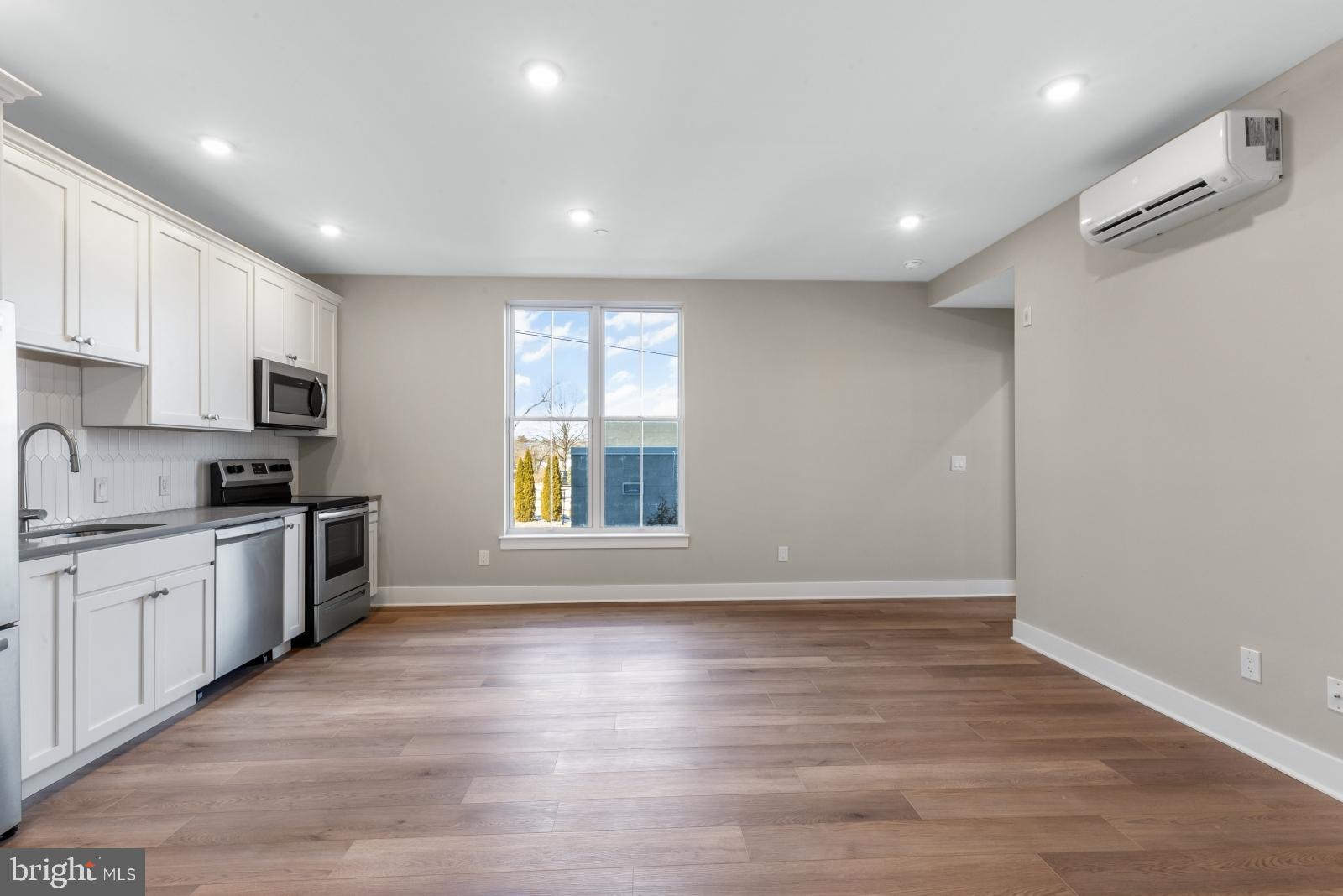 6712 Ridge Avenue, Unit 204 Philadelphia, PA 19128 - Photo 3 of 18 a large kitchen with stainless steel appliances granite countertop a large counter top a sink and a refrigerator