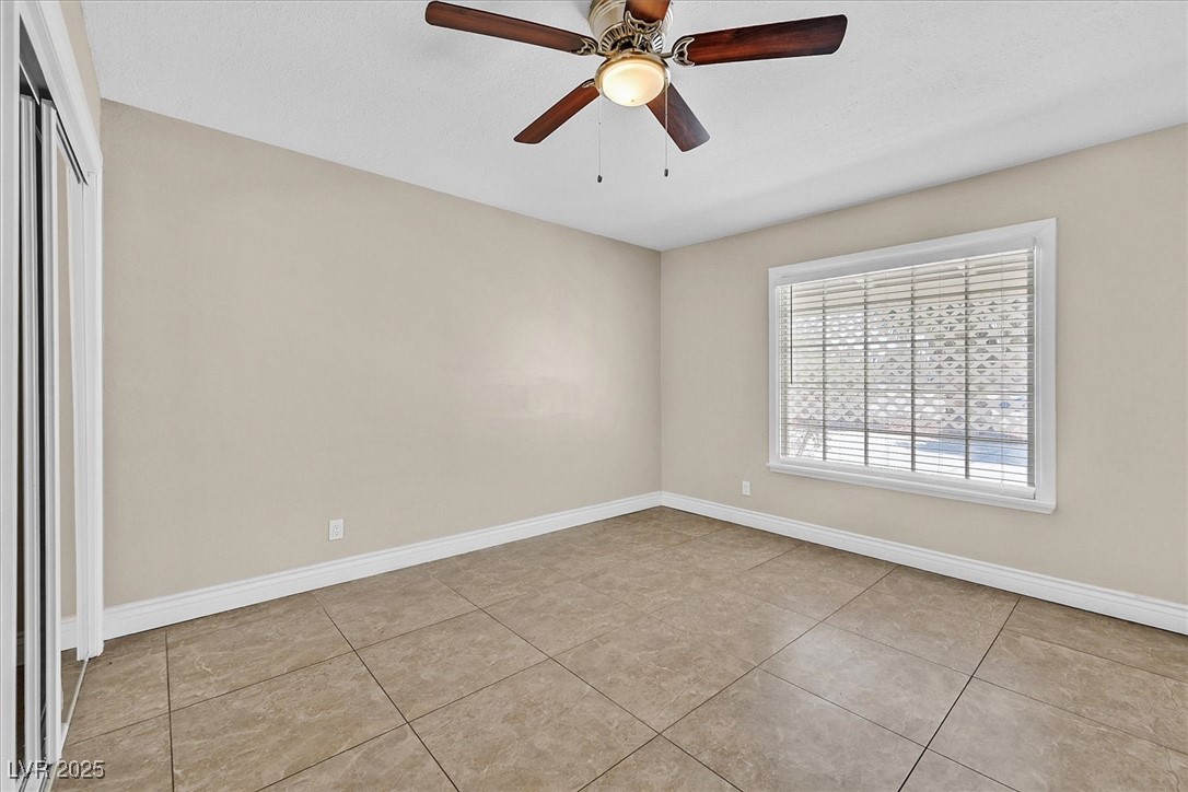 6384 West Desert Inn Road Las Vegas, NV 89146 - Photo 16 of 26 Unfurnished room featuring light tile patterned flooring and ceiling fan