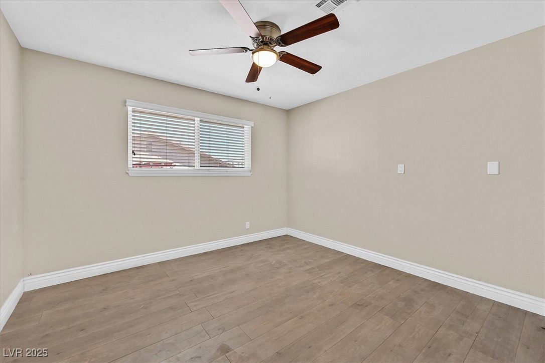 6384 West Desert Inn Road Las Vegas, NV 89146 - Photo 17 of 26 Unfurnished room with light wood-style floors and ceiling fan