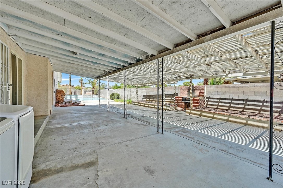 6384 West Desert Inn Road Las Vegas, NV 89146 - Photo 20 of 26 Fenced backyard featuring a patio, a pergola, and washer and dryer