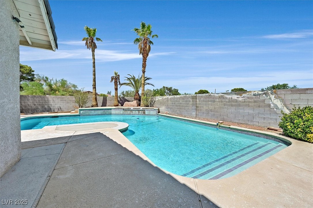 6384 West Desert Inn Road Las Vegas, NV 89146 - Photo 23 of 26 View of swimming pool featuring a patio and a fenced backyard