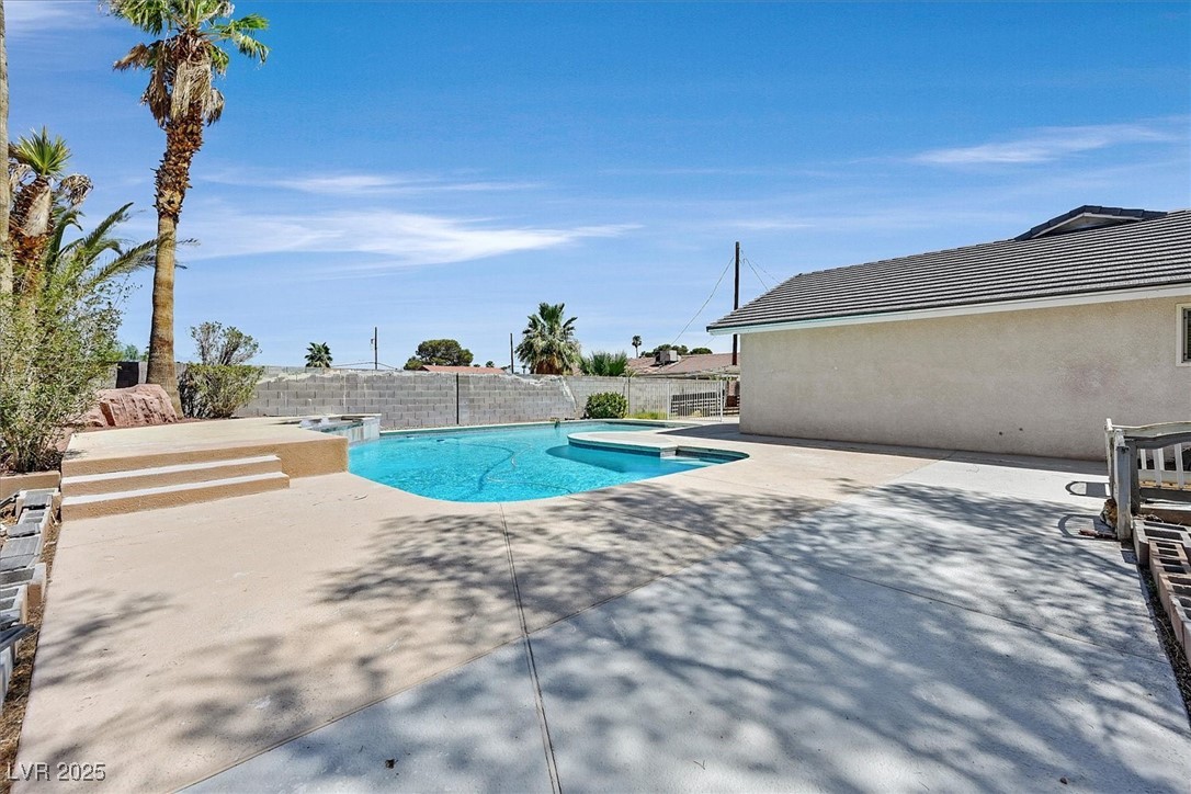 6384 West Desert Inn Road Las Vegas, NV 89146 - Photo 24 of 26 View of swimming pool featuring an in-ground hot tub, a patio, and a fenced backyard