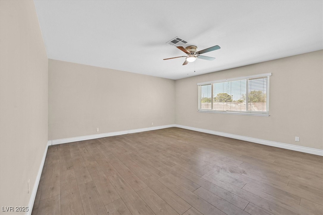 6384 West Desert Inn Road Las Vegas, NV 89146 - Photo 7 of 26 Unfurnished room with light wood finished floors and ceiling fan