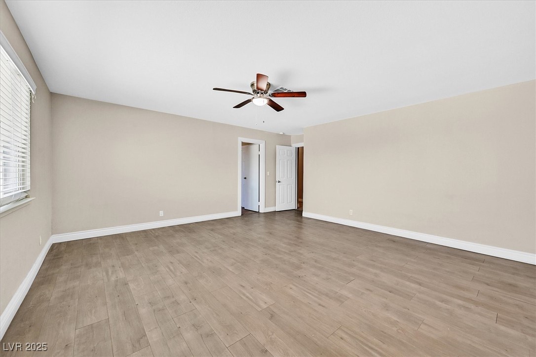 6384 West Desert Inn Road Las Vegas, NV 89146 - Photo 8 of 26 Unfurnished room featuring light wood-style floors and ceiling fan