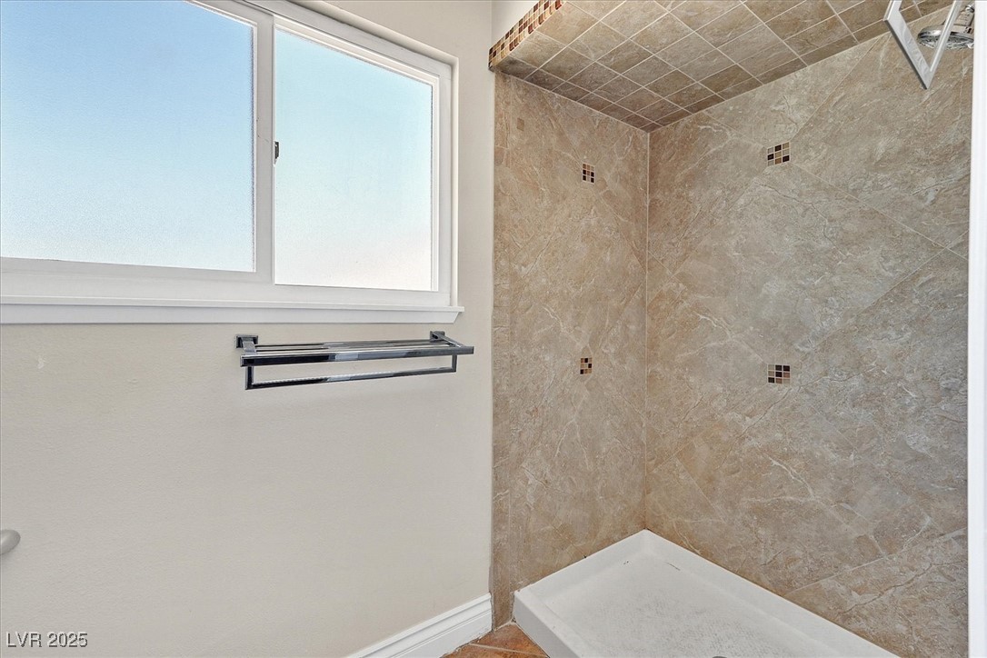 6384 West Desert Inn Road Las Vegas, NV 89146 - Photo 10 of 26 Bathroom with a stall shower and baseboards