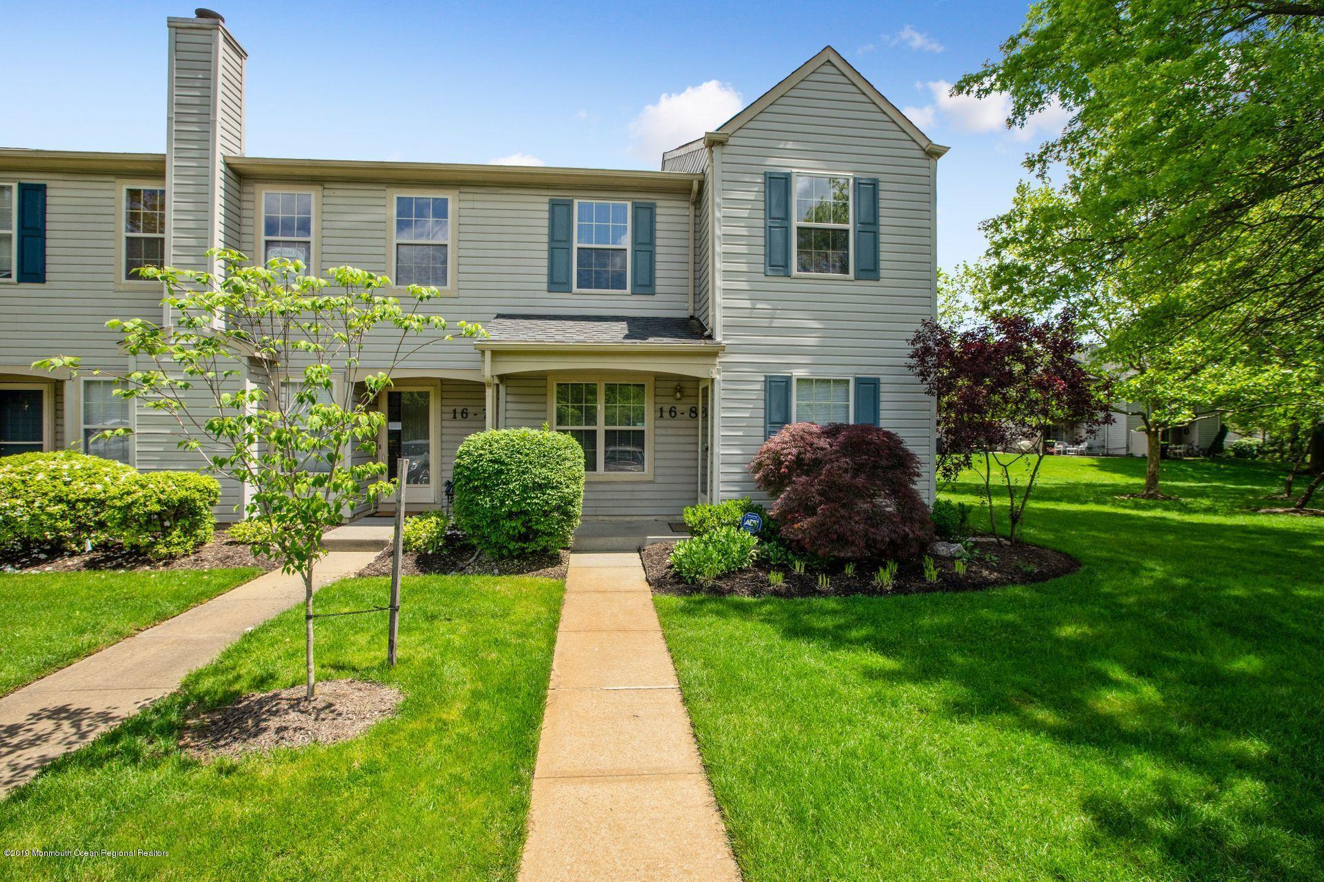 16 Stuart Drive, Unit 8 Freehold, NJ 07728 - Photo 1 of 28 a front view of a house with a yard and potted plants
