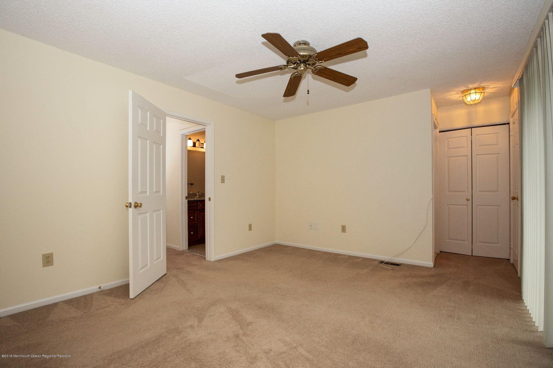 16 Stuart Drive, Unit 8 Freehold, NJ 07728 - Photo 11 of 28 wooden floor in an empty room