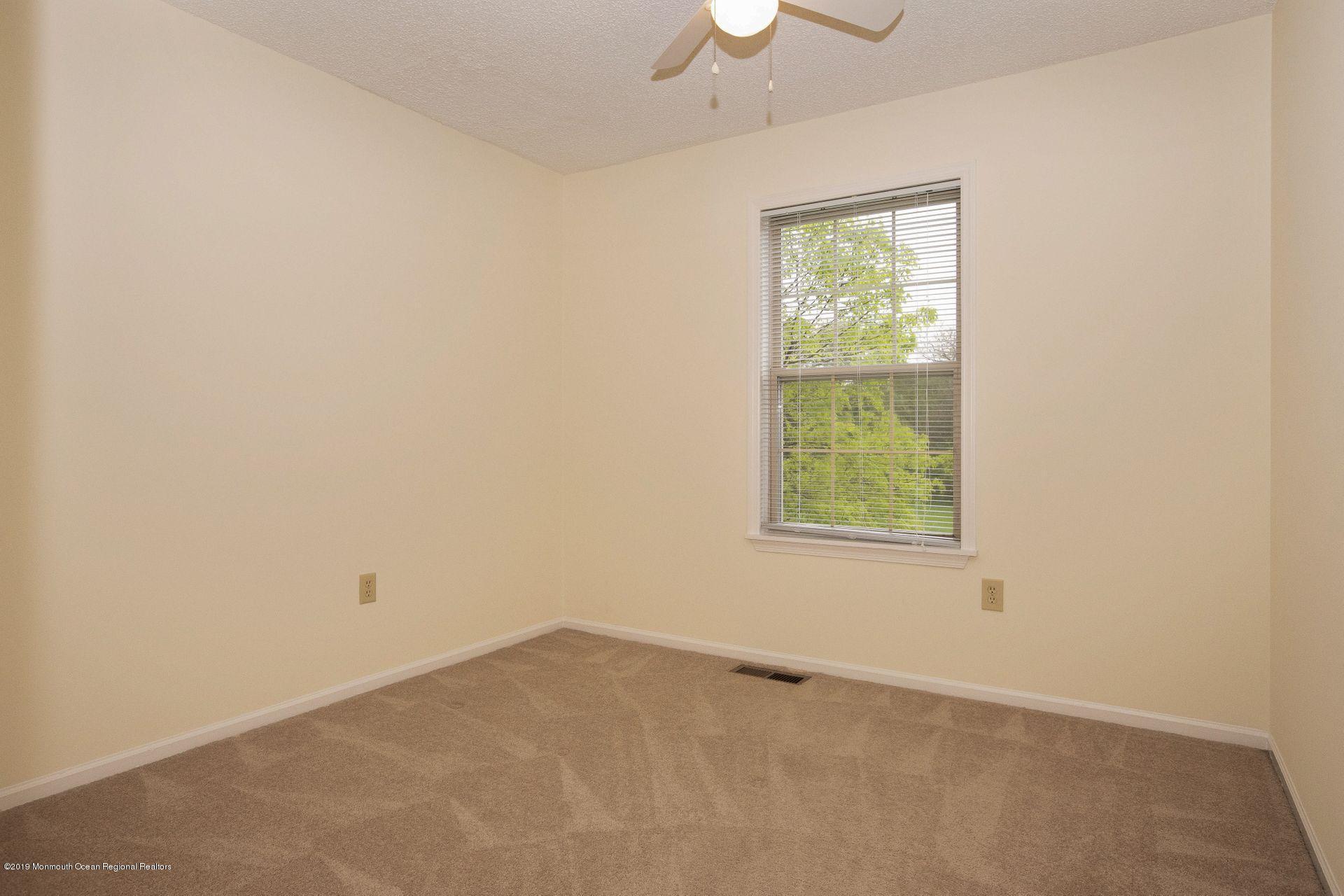 16 Stuart Drive, Unit 8 Freehold, NJ 07728 - Photo 16 of 28 an empty room with a window