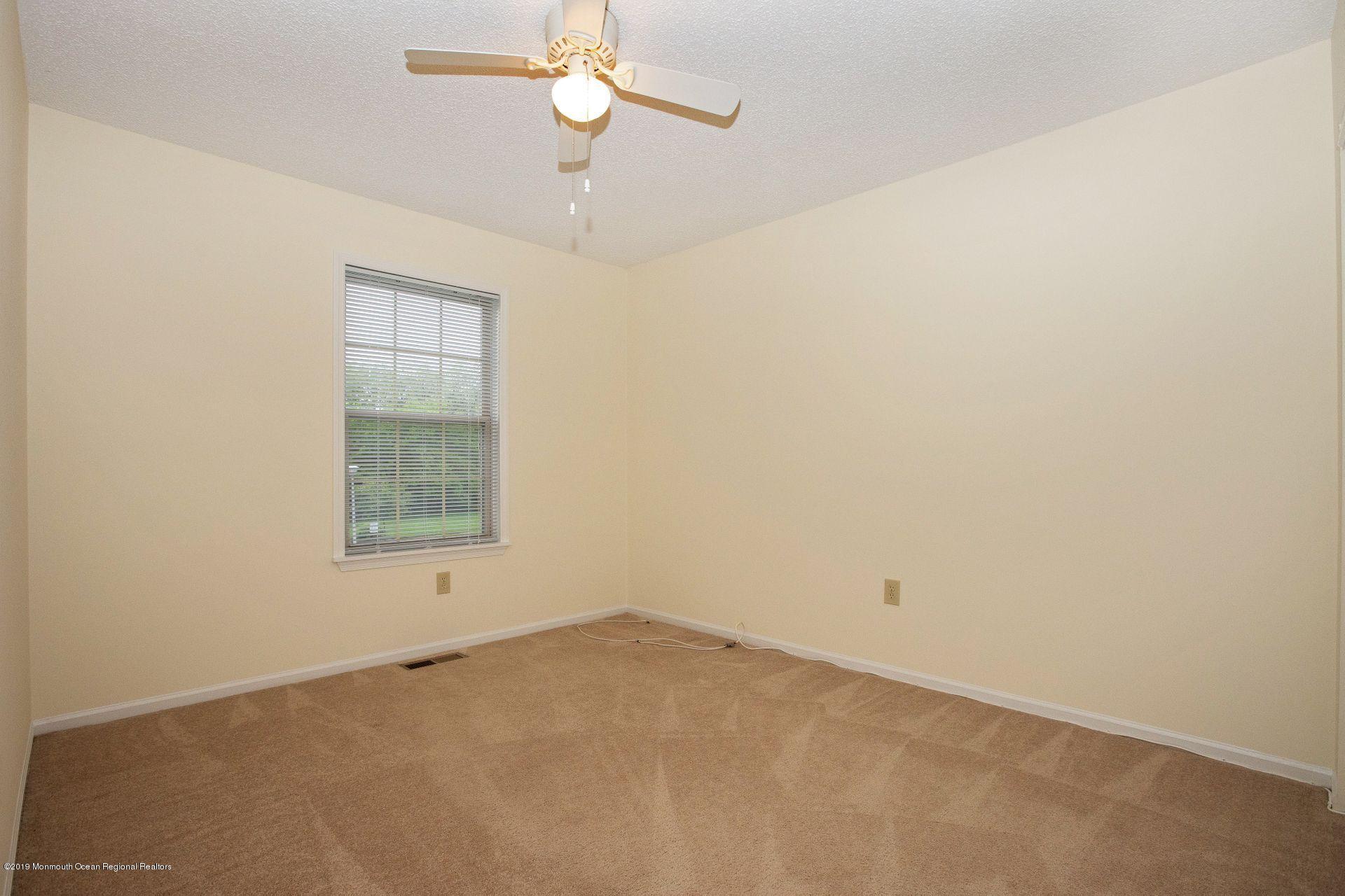 16 Stuart Drive, Unit 8 Freehold, NJ 07728 - Photo 19 of 28 an empty room with a window