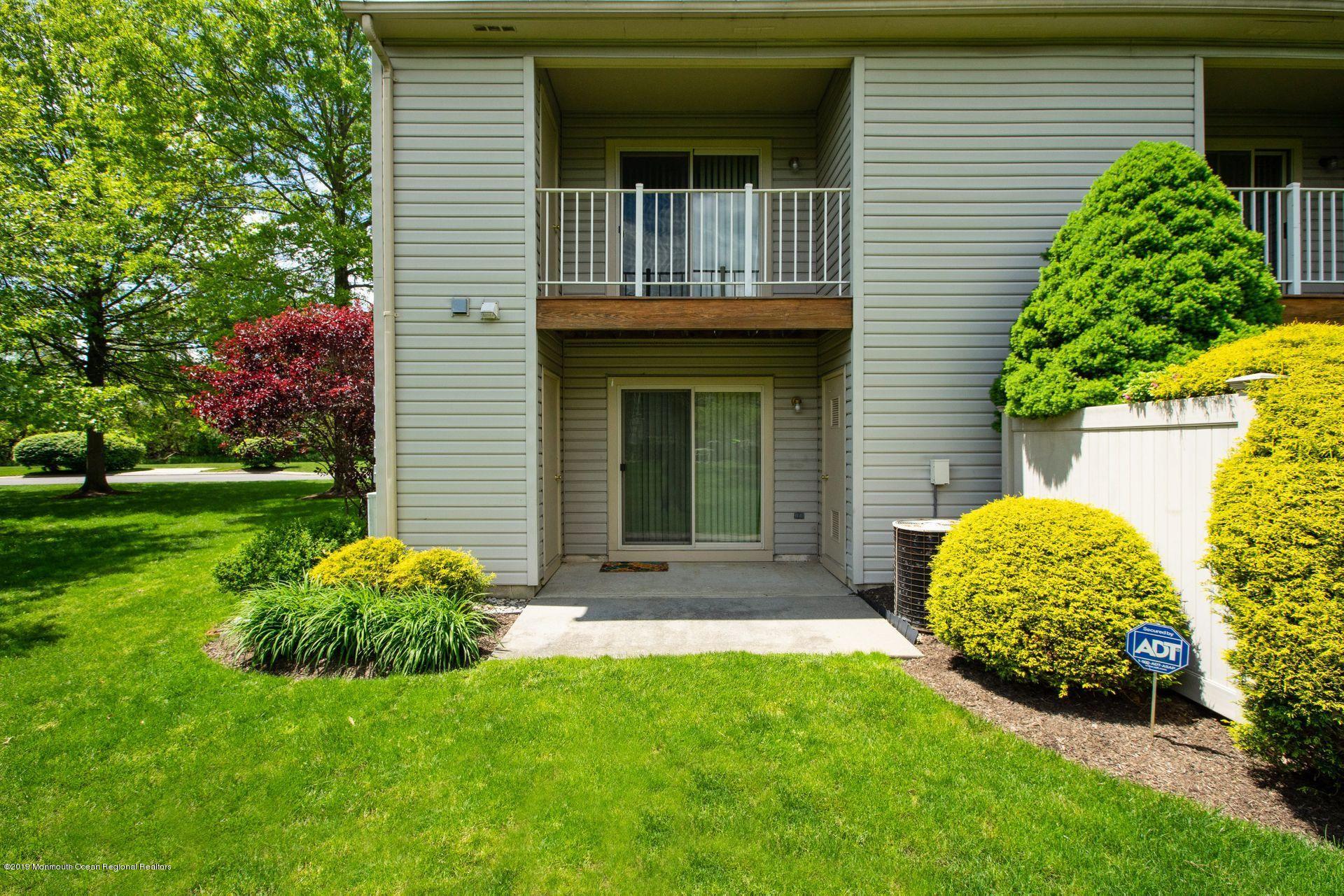16 Stuart Drive, Unit 8 Freehold, NJ 07728 - Photo 20 of 28 a view of front of a house with a yard
