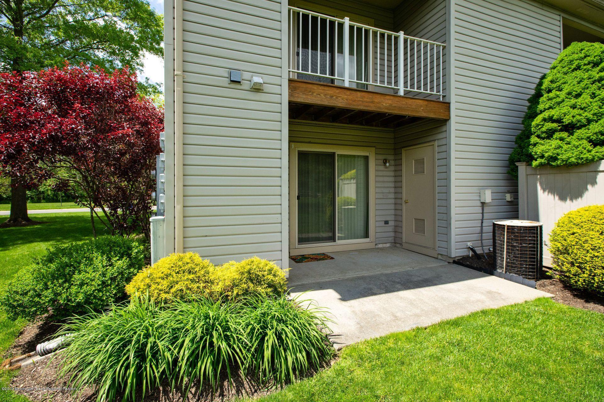 16 Stuart Drive, Unit 8 Freehold, NJ 07728 - Photo 21 of 28 a front view of a house with garden