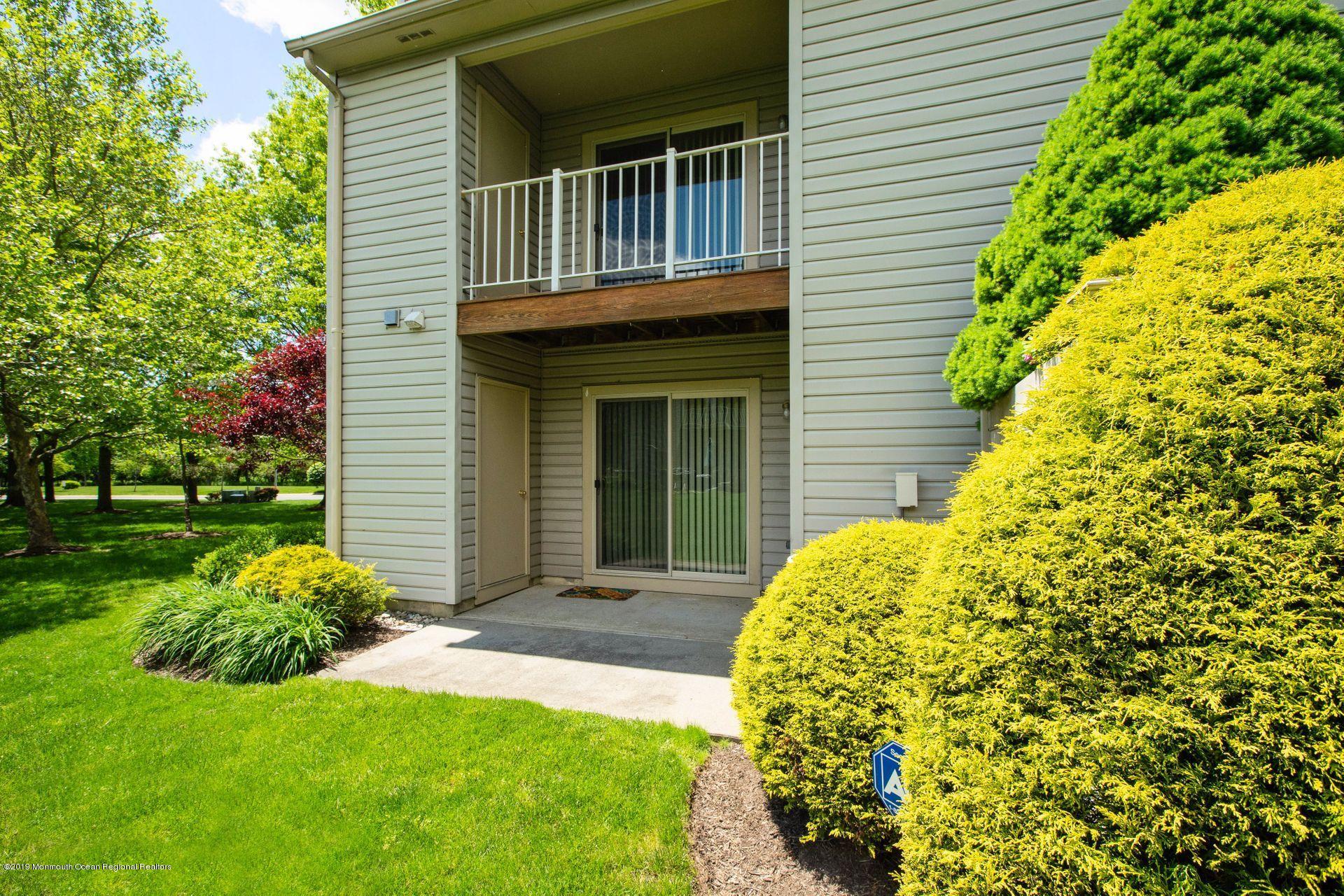 16 Stuart Drive, Unit 8 Freehold, NJ 07728 - Photo 22 of 28 a front view of a house with garden