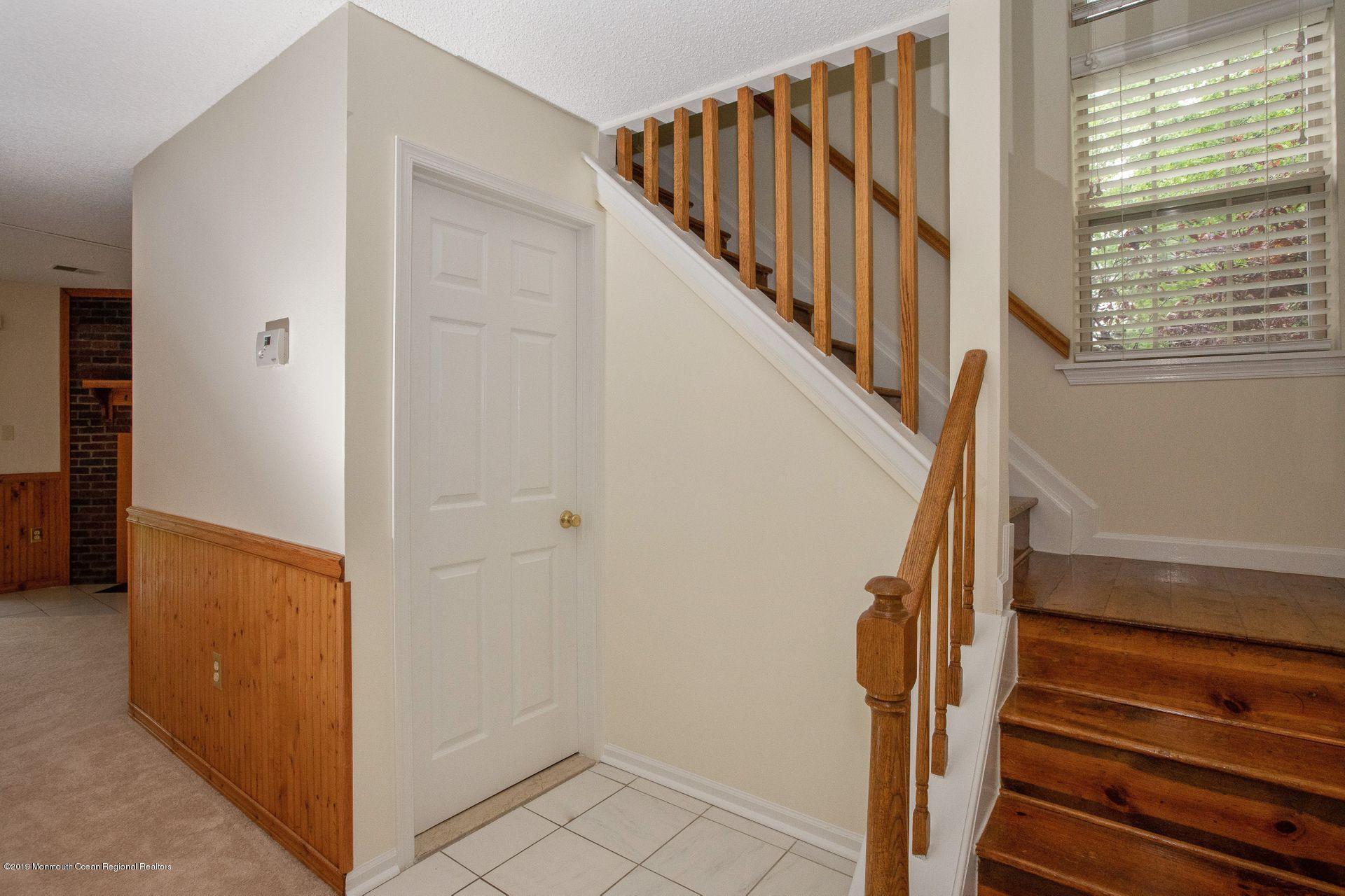 16 Stuart Drive, Unit 8 Freehold, NJ 07728 - Photo 4 of 28 a view of staircase with wooden floor and white walls