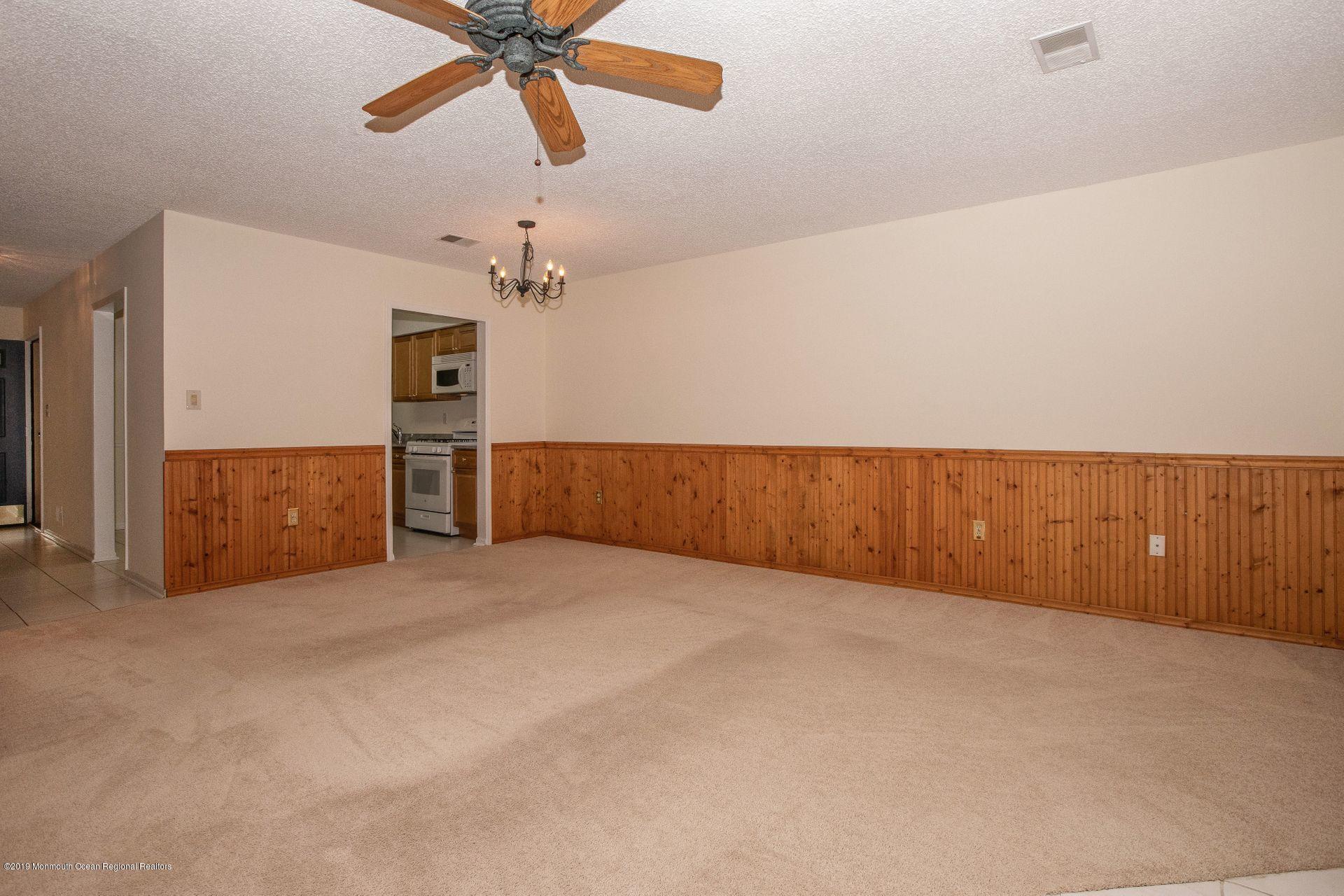 16 Stuart Drive, Unit 8 Freehold, NJ 07728 - Photo 7 of 28 an empty room with fan and windows