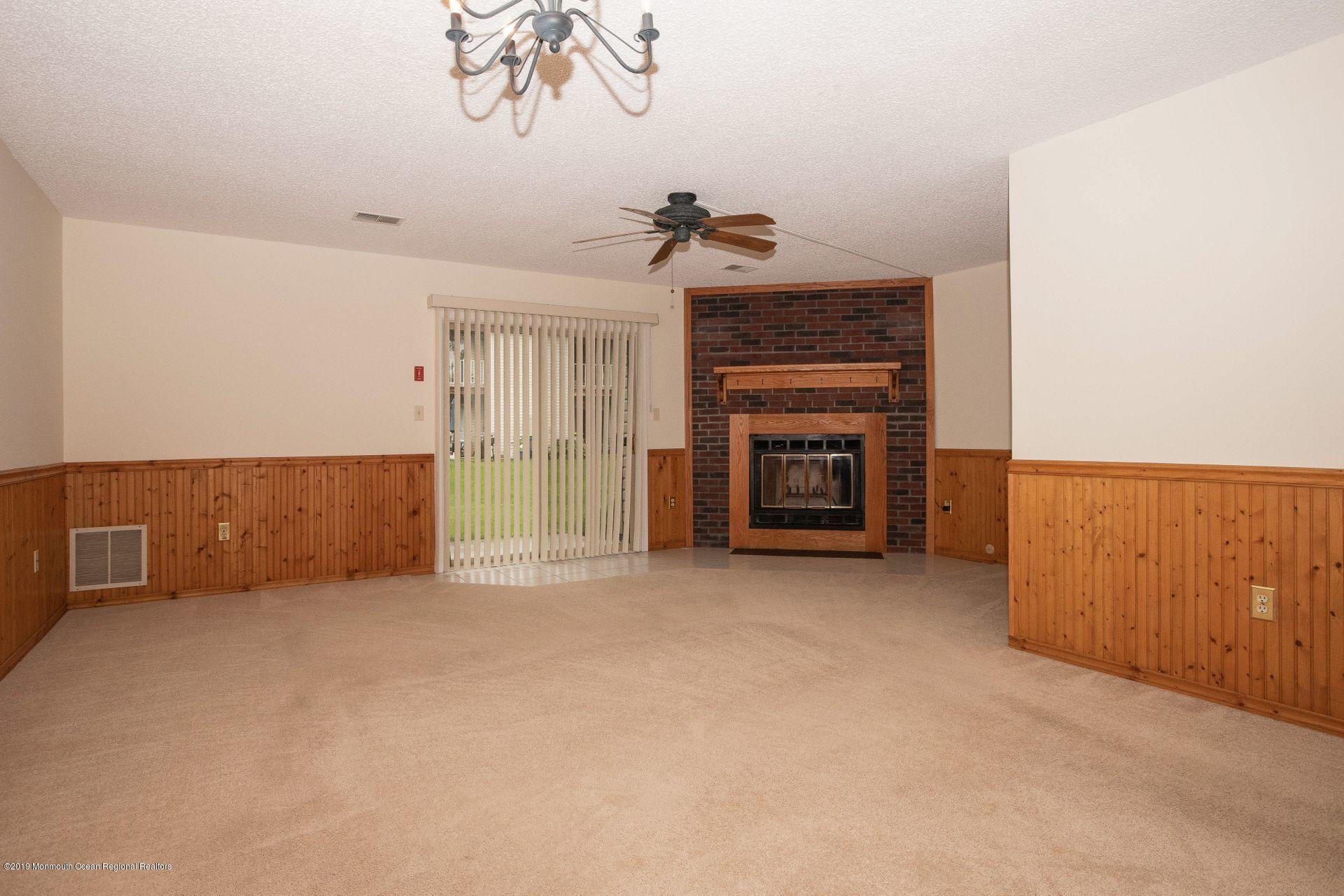 16 Stuart Drive, Unit 8 Freehold, NJ 07728 - Photo 8 of 28 a view of empty room with a fireplace