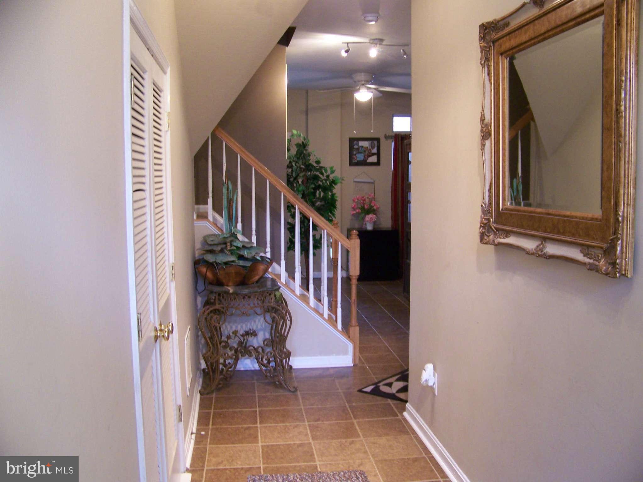 10155 Pale Rose Loop Bristow, VA 20136 - Photo 2 of 25 a view of a hallway with a door and stairs